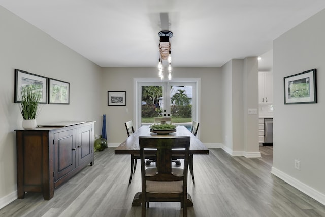 dining area with light hardwood / wood-style flooring and french doors