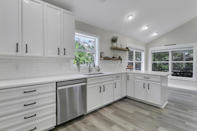 kitchen featuring white cabinetry, dishwasher, sink, and tasteful backsplash