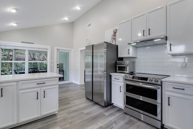 kitchen with white cabinetry, high vaulted ceiling, and stainless steel appliances