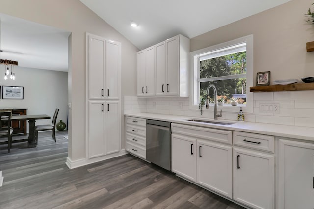 kitchen with white cabinets, decorative backsplash, stainless steel dishwasher, and sink