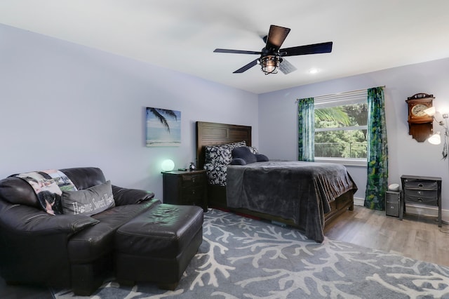 bedroom featuring hardwood / wood-style floors and ceiling fan