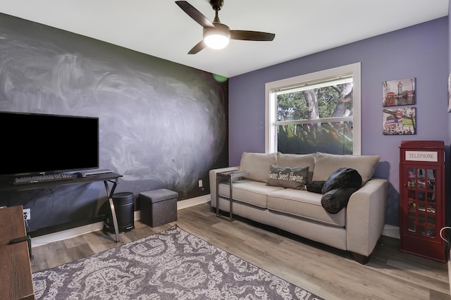 living room with ceiling fan and light wood-type flooring