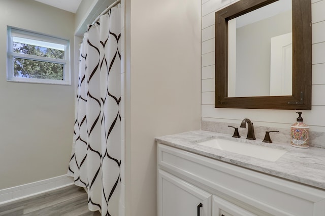 bathroom featuring hardwood / wood-style flooring, vanity, and a shower with shower curtain