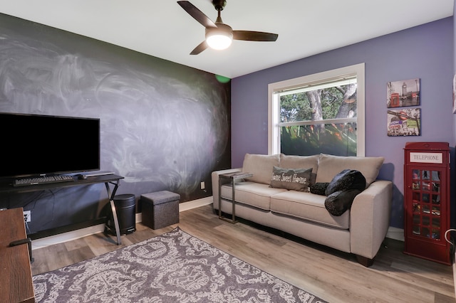 living room featuring ceiling fan and light hardwood / wood-style flooring