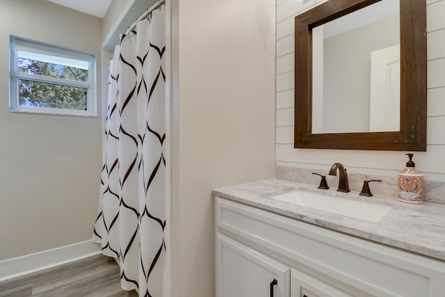 bathroom with vanity, hardwood / wood-style flooring, and walk in shower