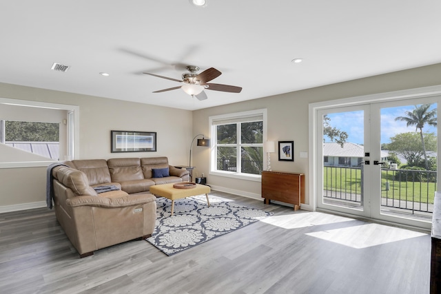 living room with ceiling fan, a healthy amount of sunlight, and hardwood / wood-style floors