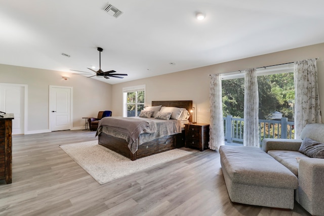 bedroom with access to outside, multiple windows, ceiling fan, and light wood-type flooring