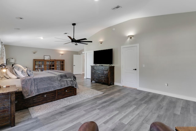 bedroom with ceiling fan, light hardwood / wood-style floors, and lofted ceiling