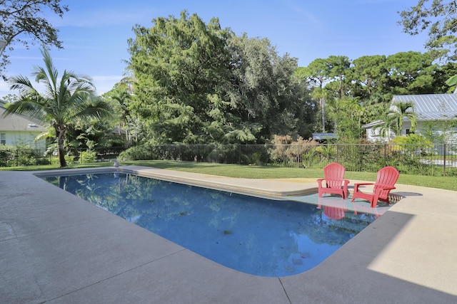 view of swimming pool with a yard and a patio area