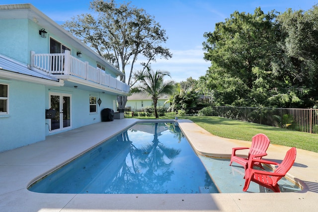 view of swimming pool with a yard, french doors, and a patio