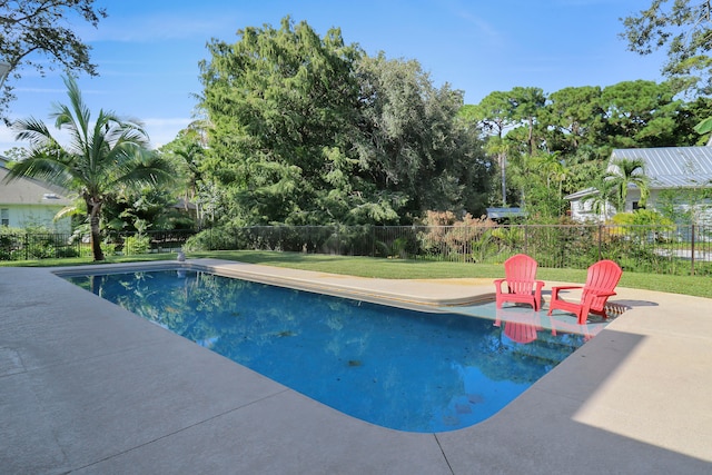 view of swimming pool featuring a yard and a patio