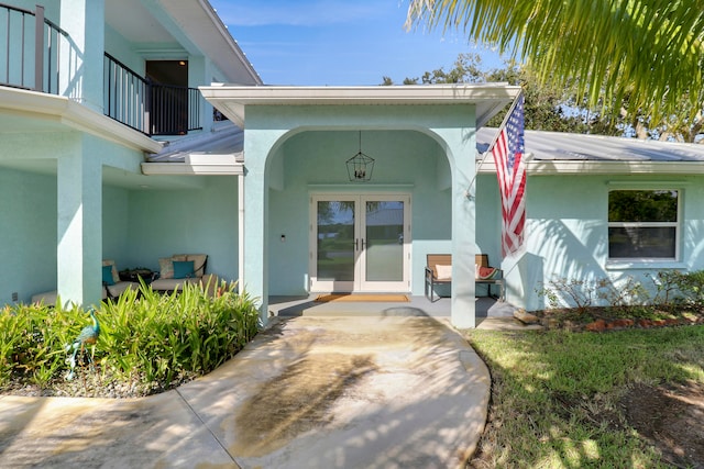 entrance to property featuring french doors and a balcony