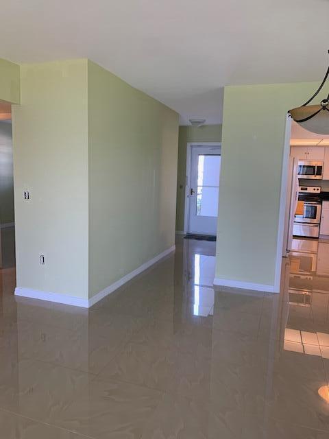 2936 Lake Shore Dr Unit 101, Riviera Beach, FL 33404 - empty room with baseboards and tile patterned floors