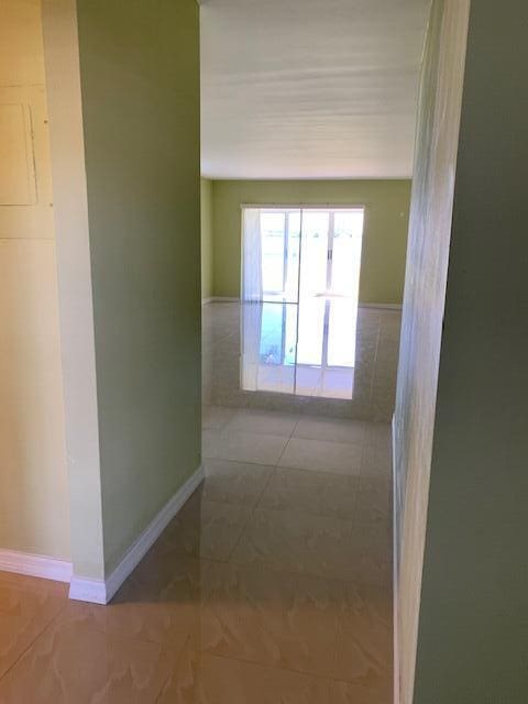 hallway with tile patterned floors