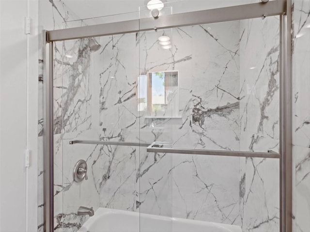 bathroom featuring shower / bath combination with glass door