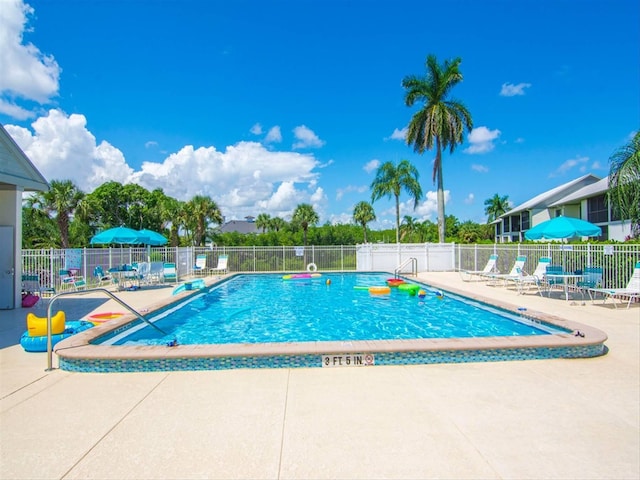 view of swimming pool with a patio area