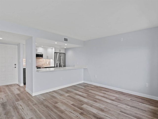 unfurnished living room with light wood-type flooring