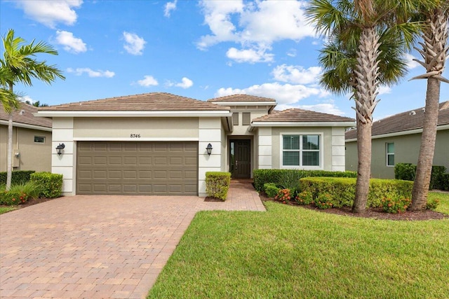 view of front facade with a garage and a front lawn