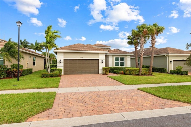 view of front of property with a garage and a front lawn