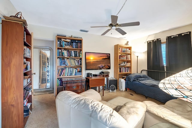 living room featuring ceiling fan and light colored carpet