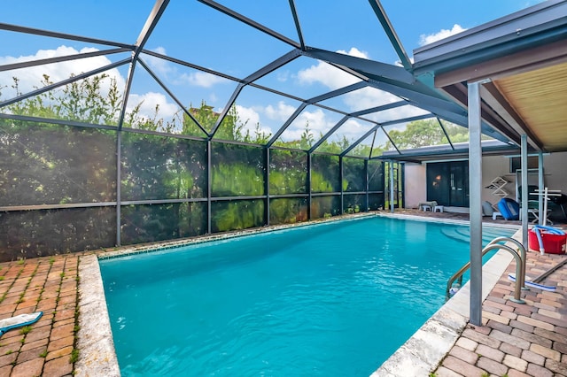 view of pool with a patio and a lanai