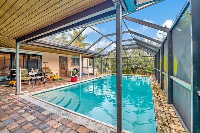 view of swimming pool with a patio and glass enclosure