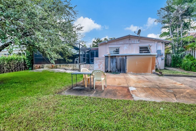 back of property with a patio and a yard