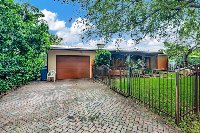 ranch-style house with a garage and a front yard