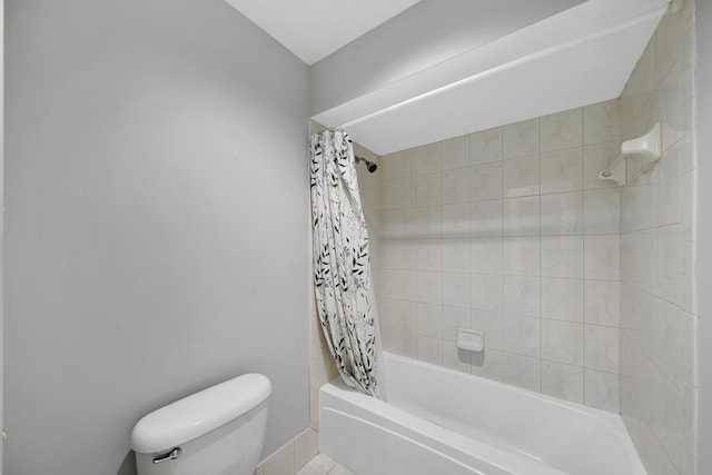 bathroom featuring shower / tub combo and toilet