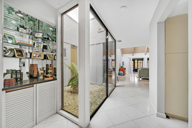 doorway with light tile patterned flooring