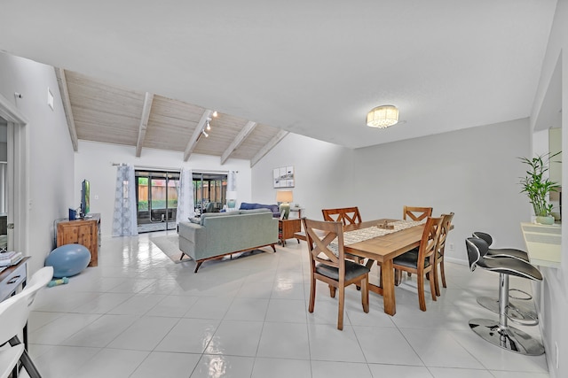 tiled dining room with lofted ceiling with beams and wooden ceiling