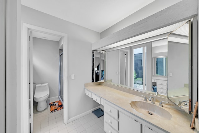 bathroom with a shower with door, toilet, vanity, and tile patterned floors