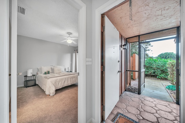 carpeted bedroom with a textured ceiling, access to outside, and ceiling fan