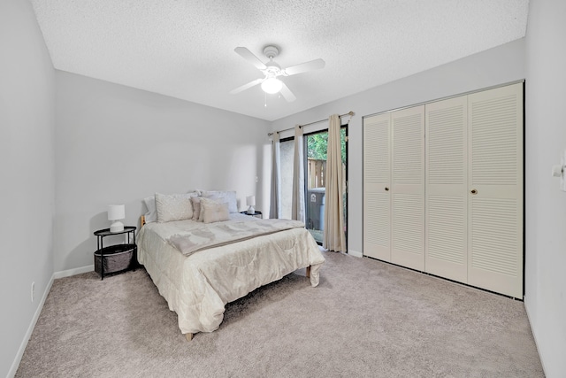 carpeted bedroom with a closet, ceiling fan, and a textured ceiling