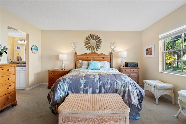 bedroom with light colored carpet and connected bathroom