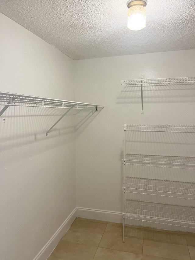 spacious closet featuring tile patterned flooring