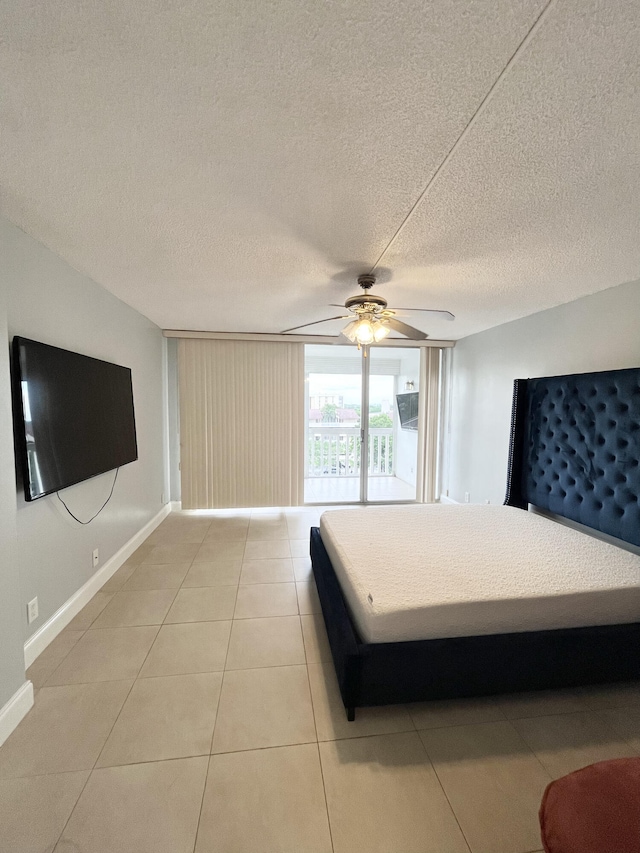 unfurnished bedroom featuring light tile patterned floors, a textured ceiling, and ceiling fan