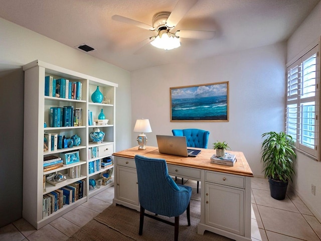 interior space with ceiling fan and light tile patterned floors