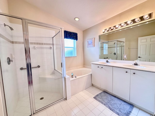 bathroom with a textured ceiling, lofted ceiling, independent shower and bath, tile patterned floors, and vanity