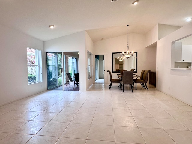 tiled dining area featuring an inviting chandelier and lofted ceiling