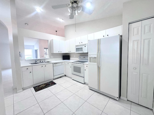 kitchen featuring white cabinetry, vaulted ceiling, white appliances, ceiling fan, and sink