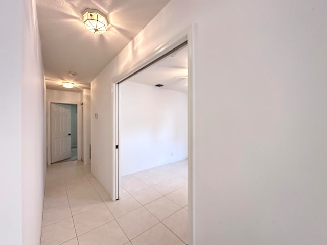 hall with light tile patterned flooring