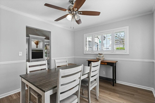 dining room with hardwood / wood-style flooring, ceiling fan, and crown molding