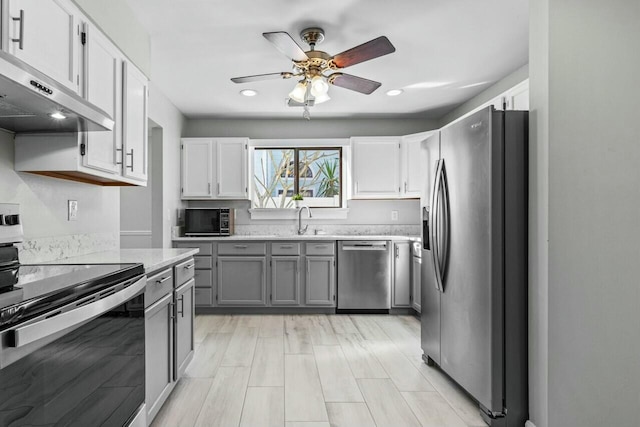 kitchen with white cabinets, gray cabinets, and appliances with stainless steel finishes