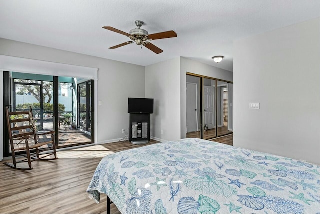 bedroom featuring a textured ceiling, access to outside, ceiling fan, wood-type flooring, and a closet