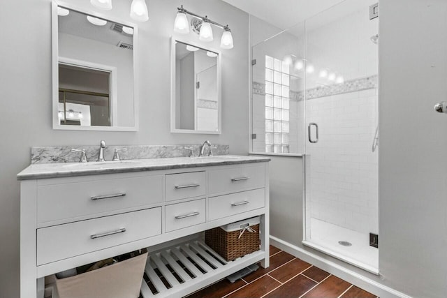 bathroom featuring vanity and an enclosed shower