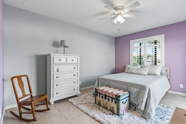 tiled bedroom featuring a textured ceiling and ceiling fan