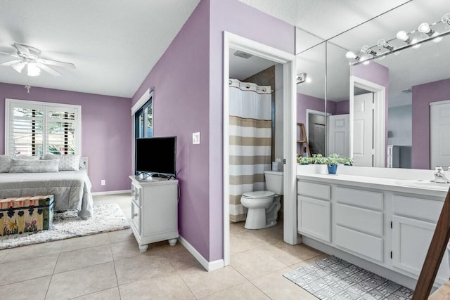 bathroom featuring tile patterned flooring, a textured ceiling, toilet, and ceiling fan