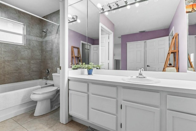 full bathroom with tile patterned flooring, vanity, toilet, and tiled shower / bath