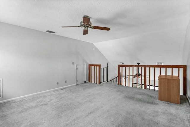 bonus room with carpet flooring, ceiling fan, a textured ceiling, and vaulted ceiling